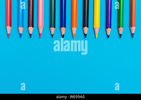 Back to scool - Pencils detail. Colored sharp pencils detail in a row, isolated on blue Stock Photo