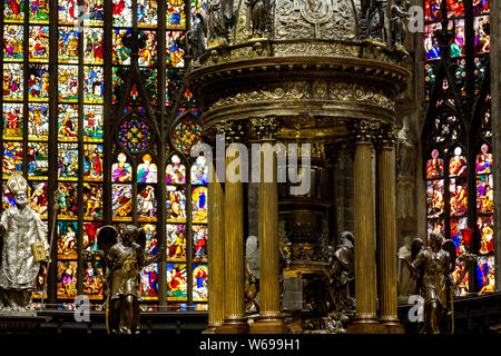 The altar with stained glass windows in the background. Duomo di Milano (Milan Cathedral). Stock Photo