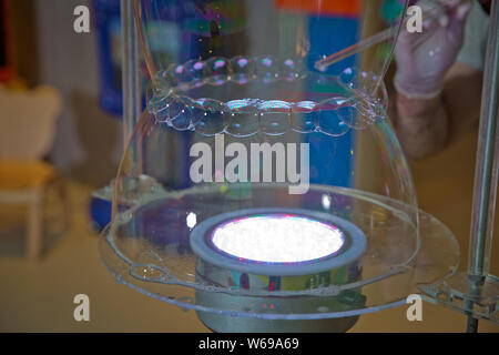 Soap bubbles show. Children's party. To burst the soap bubble Stock Photo