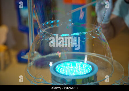 Soap bubbles show. Children's party. To burst the soap bubble Stock Photo