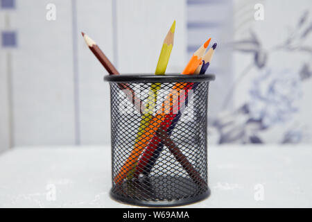 Box for pens and pencils . Colored pencils in a pencil case on white background . Color pencils in black case on white background isolated . Creative Stock Photo