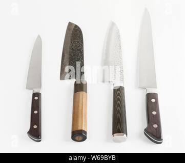 Four different knives shot on light gray surface with smooth shadows Stock Photo