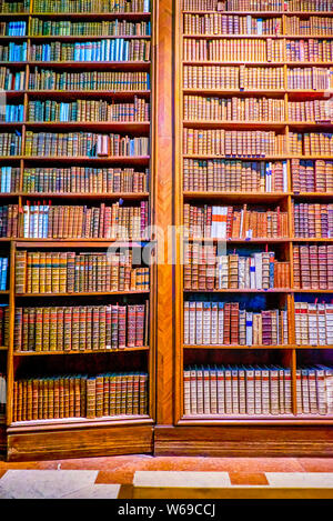 VIENNA, AUSTRIA - MARCH 2, 2019: The vintage wooden bookshelves with collection of old books in Austrian National Library in Hofburg Palace, on March Stock Photo