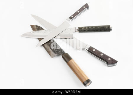 Four different knives on light gray surface Stock Photo