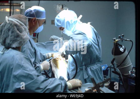 Orthopedic surgeons during knee replacement procedures in a local New Jersey hospital in 1985. Stock Photo