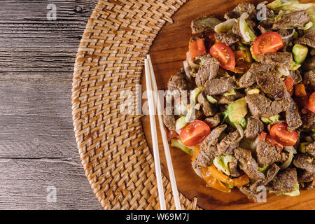 Asian, vietnam or thai cuisine. Beef with vegetable on wood plate Stock Photo