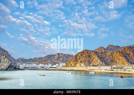 Fishing village between the mountains and the village folks fishing in the calm sea. From Muscat, Oman. Stock Photo