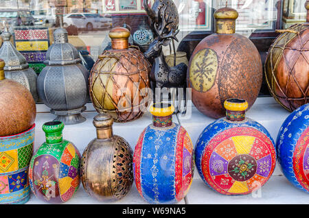Traditional artistically painted colorful pots on display in shop in Muscat, Oman. Stock Photo