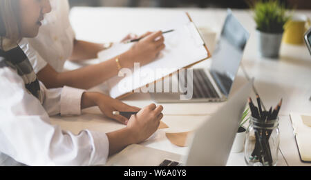 Couple of young female asian businesswoman discussing the marketing project together Stock Photo