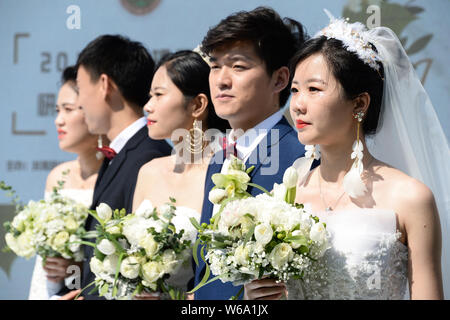 Postgraduate couples take part in a group wedding ceremony at Beijing Institute of Technology in Beijing, China, 10 June 2018.   Eighteen postgraduate Stock Photo