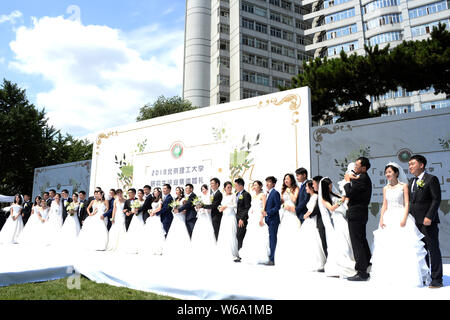 Postgraduate couples take part in a group wedding ceremony at Beijing Institute of Technology in Beijing, China, 10 June 2018.   Eighteen postgraduate Stock Photo