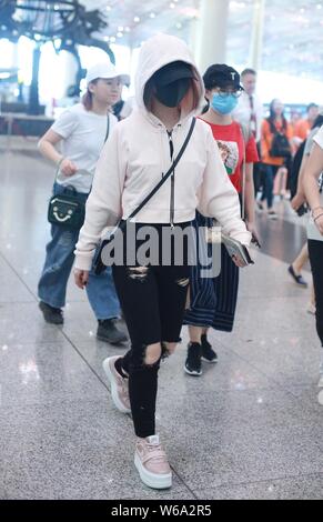 Hong Kong singer Gloria Tang Tsz-kei, also known by her stage name G.E.M., is pictured as she arrives at the Beijing Capital International Airport in Stock Photo