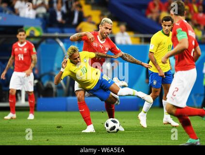 Neymar of Brazil, front, challenges Valon Behrami of Switzerland in their Group E match during the 2018 FIFA World Cup in Rostov, Russia, 17 June 2018 Stock Photo