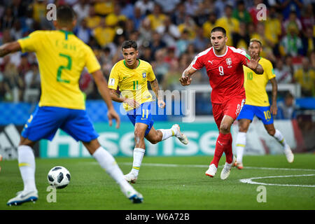 Philippe Coutinho of Brazil, center, challenges Aleksandar Mitrovic of Serbia in their Group E match during the FIFA World Cup 2018 in Moscow, Russia, Stock Photo
