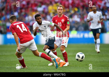 Thomas Lemar of France, center, challenges Henrik Dalsgaard and Christian Eriksen of Denmark in their Group C match during the 2018 FIFA World Cup in Stock Photo