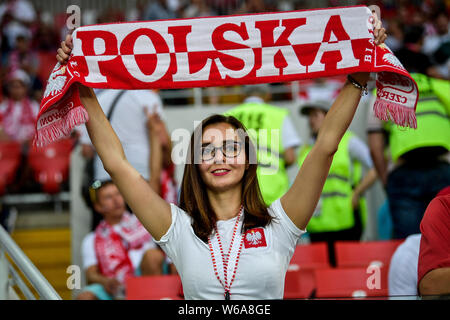 A hot female Polish fan wearing a red and white jersey watches the Group H match between Poland and Senegal during the 2018 FIFA World Cup in Moscow, Stock Photo