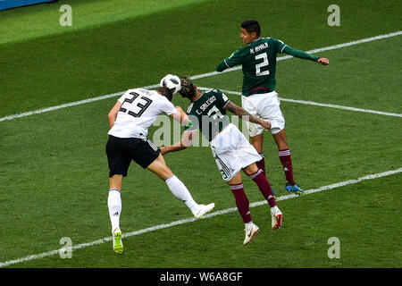 Carlos Salcedo of Mexico, center, heads the ball against Mario Gomez of Germany in their Group F match during the 2018 FIFA World Cup in Moscow, Russi Stock Photo