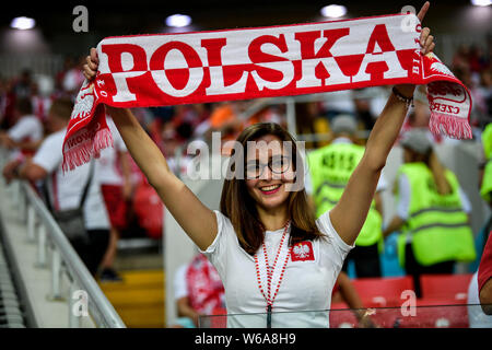 A hot female Polish fan wearing a red and white jersey watches the Group H match between Poland and Senegal during the 2018 FIFA World Cup in Moscow, Stock Photo