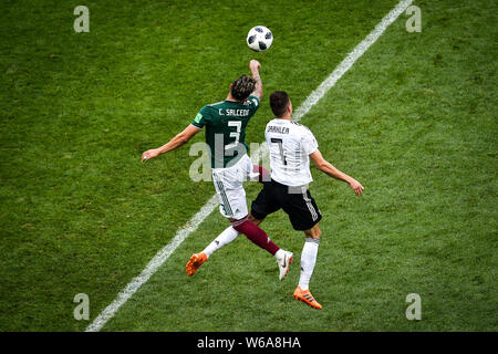 Carlos Salcedo of Mexico, left, challenges Julian Draxler of Germany in their Group F match during the 2018 FIFA World Cup in Moscow, Russia, 17 June Stock Photo