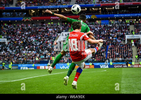 Yuri Zhirkov of Russia, front, heads the ball against a player of Saudi Arabia in their Group A match during the 2018 FIFA World Cup in Moscow, Russia Stock Photo