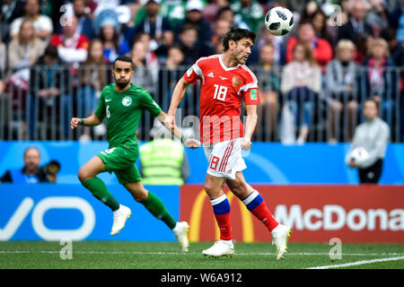 Yuri Zhirkov of Russia, right, heads the ball against Saudi Arabia in their Group A match during the 2018 FIFA World Cup in Moscow, Russia, 14 June 20 Stock Photo