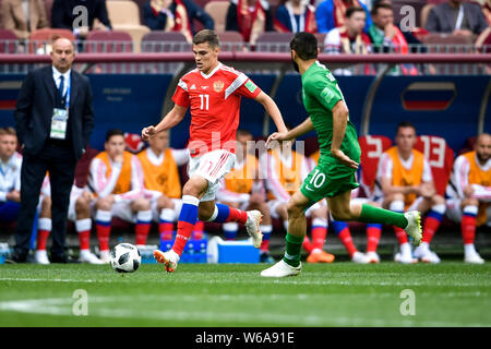 Roman Zobnin of Russia, left, challenges Mohammad Al-Sahlawi of Saudi Arabia in their Group A match during the 2018 FIFA World Cup in Moscow, Russia, Stock Photo