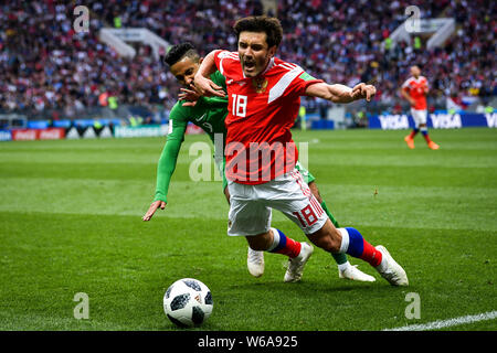 Yuri Zhirkov of Russia, right, challenges a player of Saudi Arabia in their Group A match during the 2018 FIFA World Cup in Moscow, Russia, 14 June 20 Stock Photo