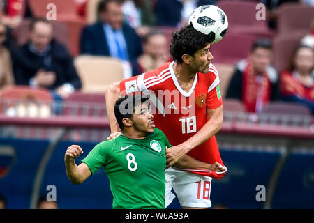 Yuri Zhirkov of Russia, right, heads the ball against Yury Gazinsky of Saudi Arabia in their Group A match during the 2018 FIFA World Cup in Moscow, R Stock Photo