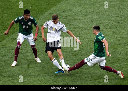 Thomas Mueller (Muller) of Germany, center, challenges Hector Herrera, right, and Jesus Gallardo of Mexico in their Group F match during the FIFA Worl Stock Photo