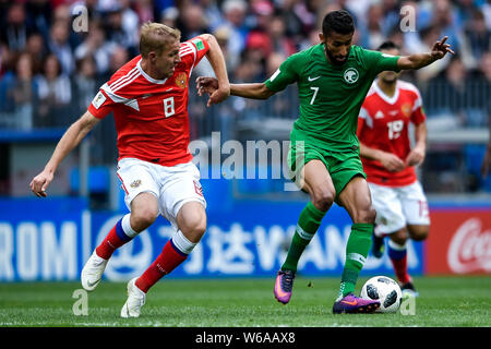 Yury Gazinsky of Russia, left, challenges Salman Al-Faraj of Saudi Arabia in their Group A match during the 2018 FIFA World Cup in Moscow, Russia, 14 Stock Photo