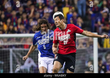 Spanish retired football player Carles Puyol, left, of International Legends challenges Yang Chen of Chinese Celebrity during the 2018 Super Penguin S Stock Photo