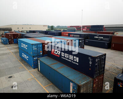 Cargo containers shipped by freight trains of the China-Europe Railway Express are stacked at the Chengdu Railway Port Multimodal Transport Customs Su Stock Photo