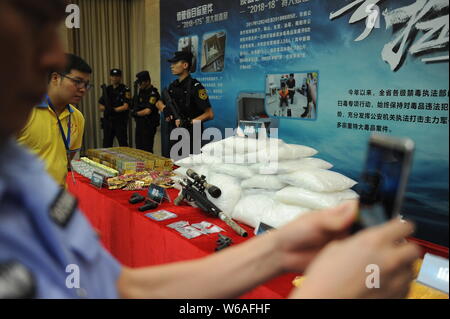 FILE--A Chinese police officer and workers confiscate fake Louis Vuitton  handbags at a warehouse in Guangzhou city, south Chinas Guangdong province  Stock Photo - Alamy