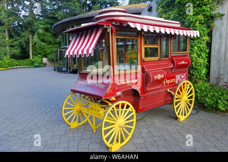 Antique Red Popcorn Wagon Restoration Model With Yellow Wooden Wheels Stock Photo