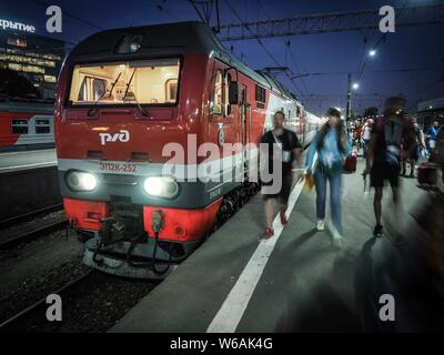 Football fans get off a 2018 FIFA World Cup free train carrying fans and FIFA accredited media representatives after arriving at a railway station in Stock Photo