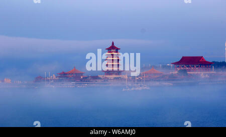 A pavilion is surrounded by mist and cloud in Penglai city, Yantai city, east China's Shandong province, 20 June 2018. Stock Photo