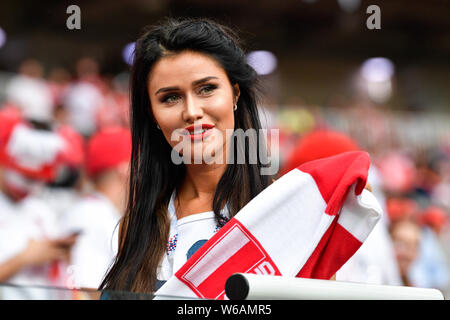 A hot female Polish fan wearing a red and white jersey watches the Group H match between Poland and Senegal during the 2018 FIFA World Cup in Moscow, Stock Photo