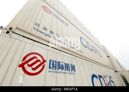 Cargo containers shipped by freight trains of the China-Europe Railway Express are stacked at the Chengdu Railway Port Multimodal Transport Customs Su Stock Photo