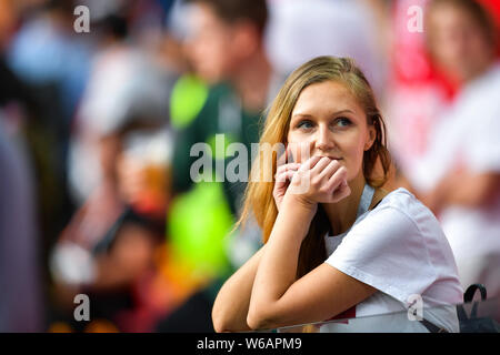 A hot female Polish fan wearing a red and white jersey watches the Group H match between Poland and Senegal during the 2018 FIFA World Cup in Moscow, Stock Photo