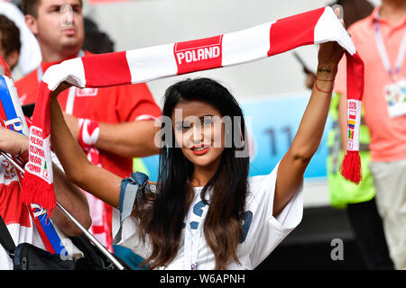 A hot female Polish fan wearing a red and white jersey watches the Group H match between Poland and Senegal during the 2018 FIFA World Cup in Moscow, Stock Photo