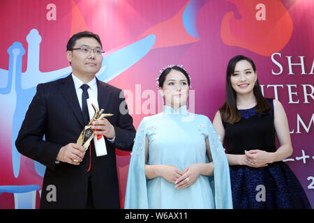 Batbayar Chogsom, left, director of 'Out of Paradise', wins the Best Feature Film award at the awarding ceremony of the 21st Golden Goblet Awards duri Stock Photo