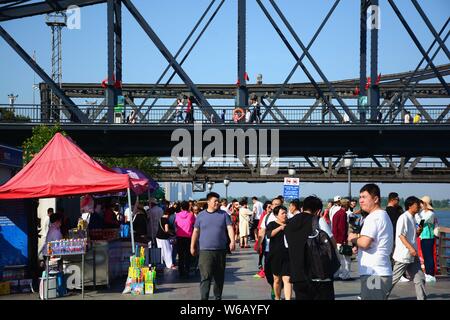 Tourists look far into the distance over Sinuiju of North Korea on the other side of Yalu River, also called the Amrok River or Amnok River, on the bo Stock Photo