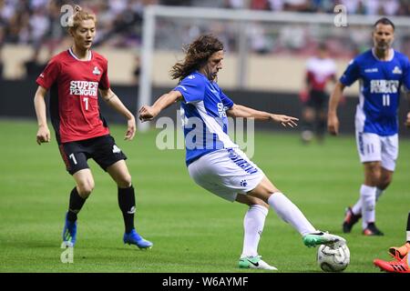 Spanish retired football player Carles Puyol of International Legends dribbles the ball against Chinese Celebrity during the 2018 Super Penguin Soccer Stock Photo