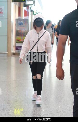 Hong Kong singer Gloria Tang Tsz-kei, also known by her stage name G.E.M., is pictured as she arrives at the Beijing Capital International Airport in Stock Photo