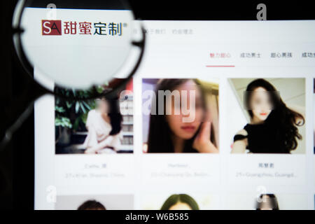 A Chinese netizen browses the dating website SeekingArrangement (SA) for people seeking 'sugar daddies' or 'sugar babies' on his computer in Beijing, Stock Photo