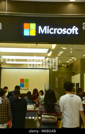--FILE--Pedestrians walk into a store of Microsoft in Daxing district, Beijing, China, 24 October 2017.   Technology companies dominated this year's F Stock Photo