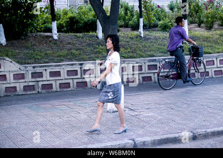 --FILE--A North Korean woman walks on the street in Pyongyang, North Korea, 28 August 2016. Stock Photo