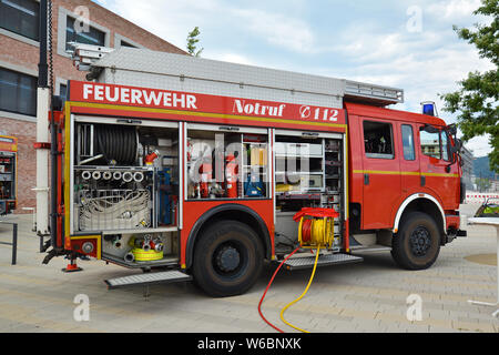 Open red german fire truck with different hoses and fire fight equipment Stock Photo