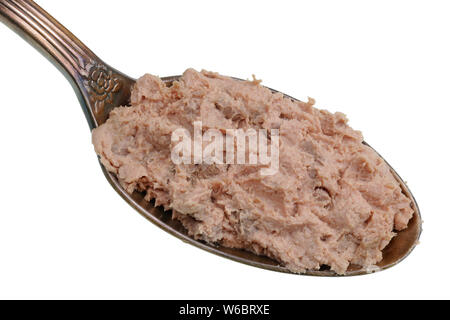 In the old golden spoon there is a small piece  of food - beef liver pate. Isolated on white studio macro Stock Photo