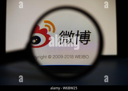 --FILE--A Chinese netizen looks at a logo of Weibo, the Twitter-like microblogging service of Chinese Internet portal Sina, on his smartphone in Ji'na Stock Photo